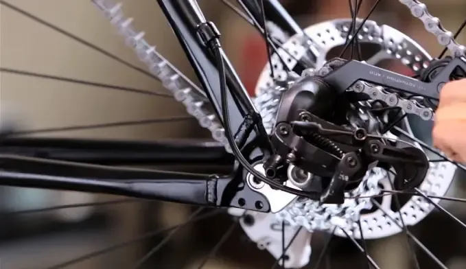 Rear bicycle wheel with a disc brake rotor removed for tire service
