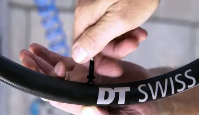 Tubeless bicycle valve stem removed from a taped rim