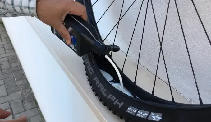Installing a tubeless bicycle tire on a wheel