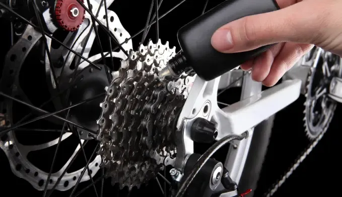 Applying lubricant to the rollers of a bicycle chain