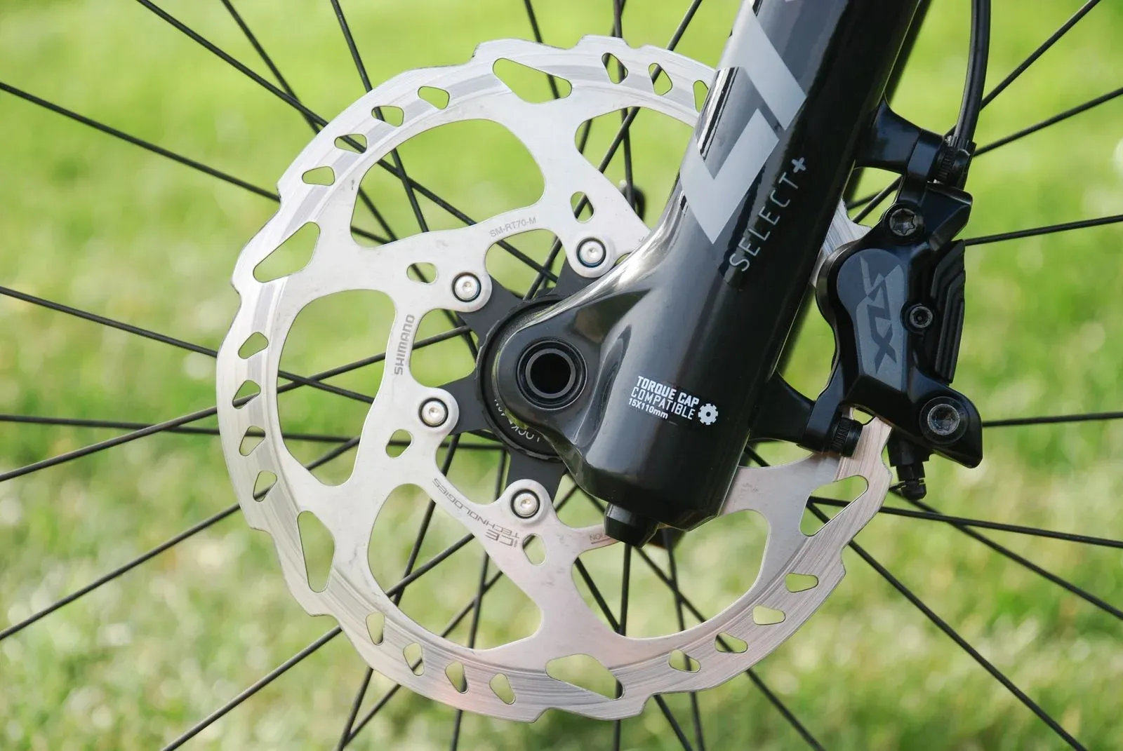 Close view of a bicycle disc brake rotor and caliper