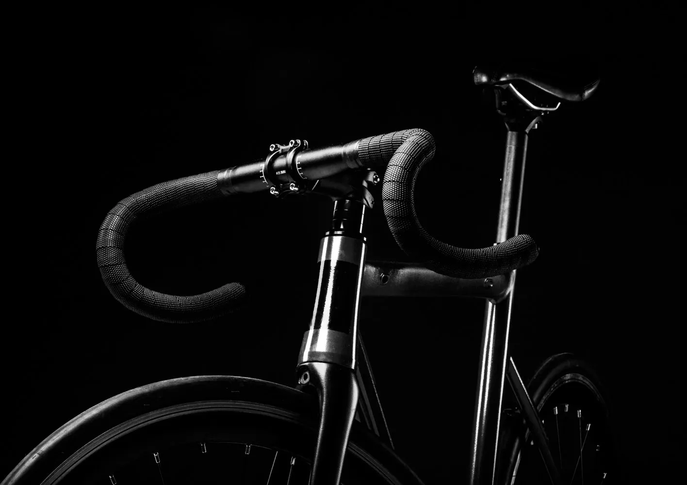 Bicycle frame and wheel secured to a rack with a U-lock